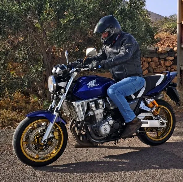 Rider on a blue Honda CB1300 setting off at the start of a full island motorcycle tour in Fuerteventura.