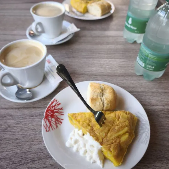 Rider enjoying a tapas stop with coffee and water at a café in La Caldereta during a motorcycle tour in Fuerteventura.