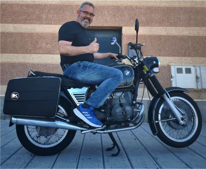 Javier, motorcycle tour guide, with a classic BMW R60/5 vintage motorbike during a guided tour experience in Fuerteventura.