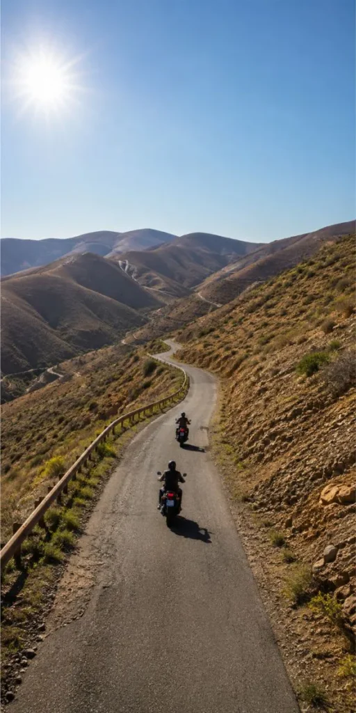 Group of motorcycles riding on secondary mountain roads in Fuerteventura during a guided motorcycle tour holiday experience.